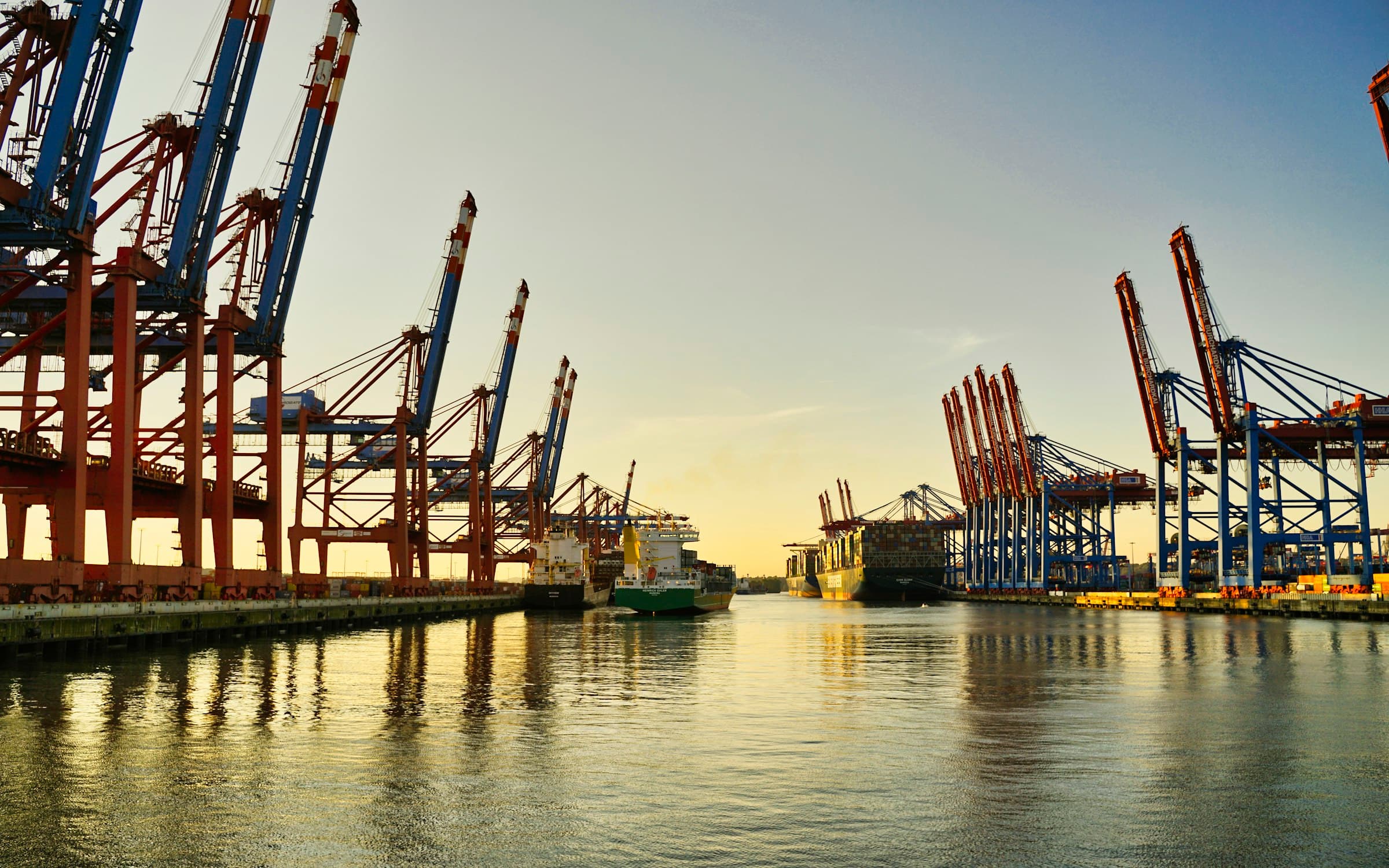 International port at dusk with container loading cranes